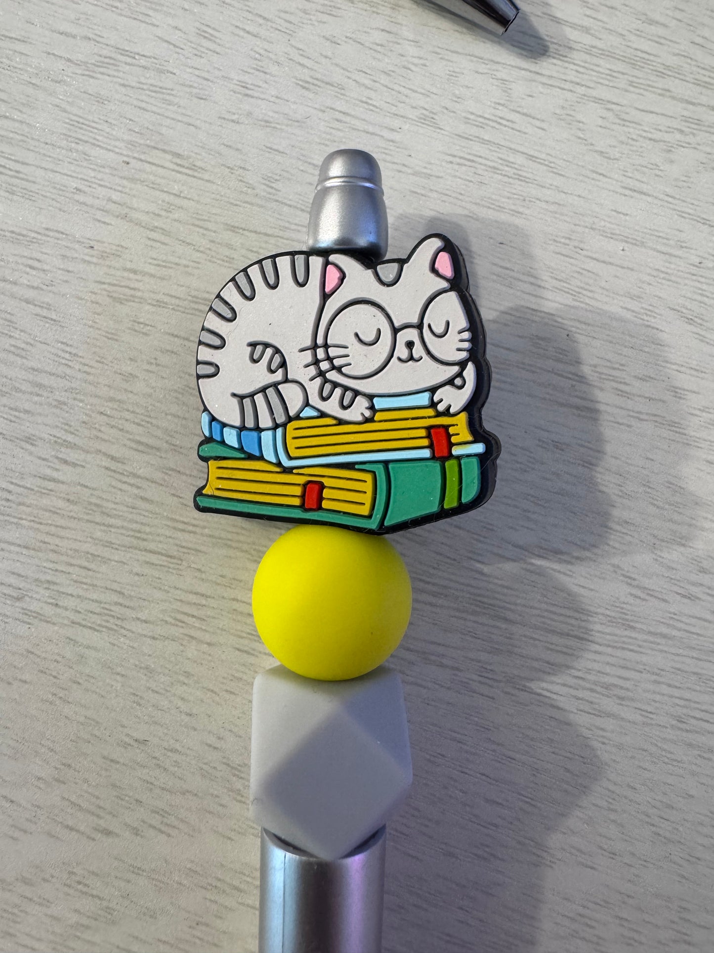 Kitty with glasses on books