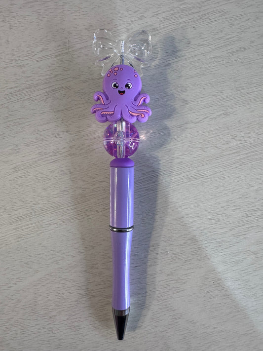 Purple octopus with bow and water bead
