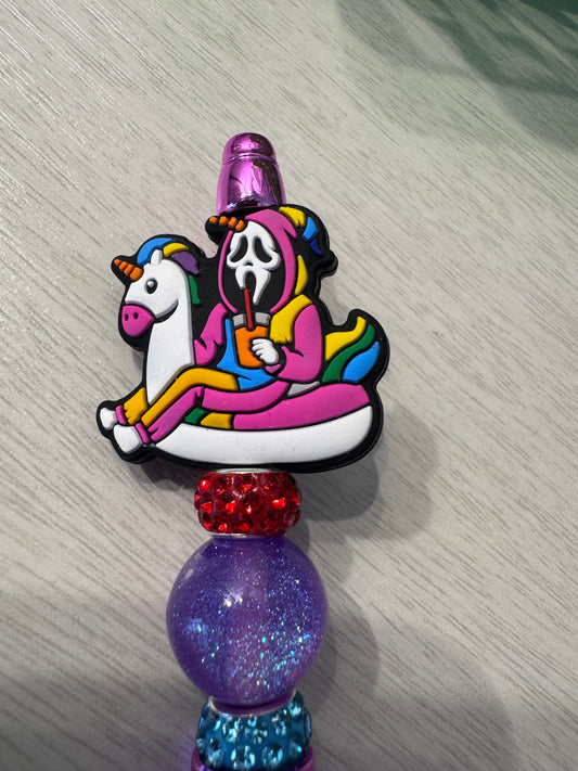 Scream, ghost face in unicorn suit in unicorn floaty drinking.