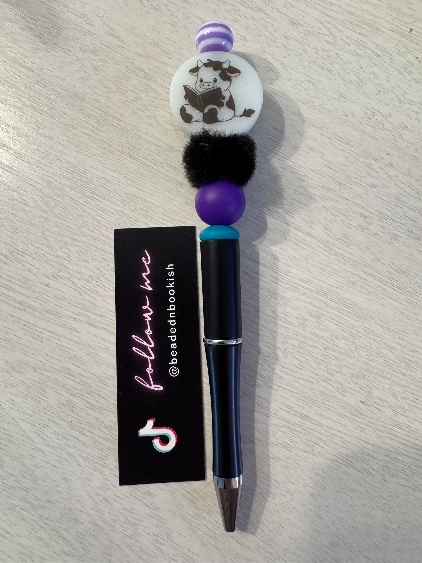 Book reading cow with fluffy bead